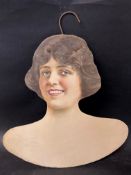 A Modelo Garment Hanger Co. coathanger in form of a lady's head and shoulders.