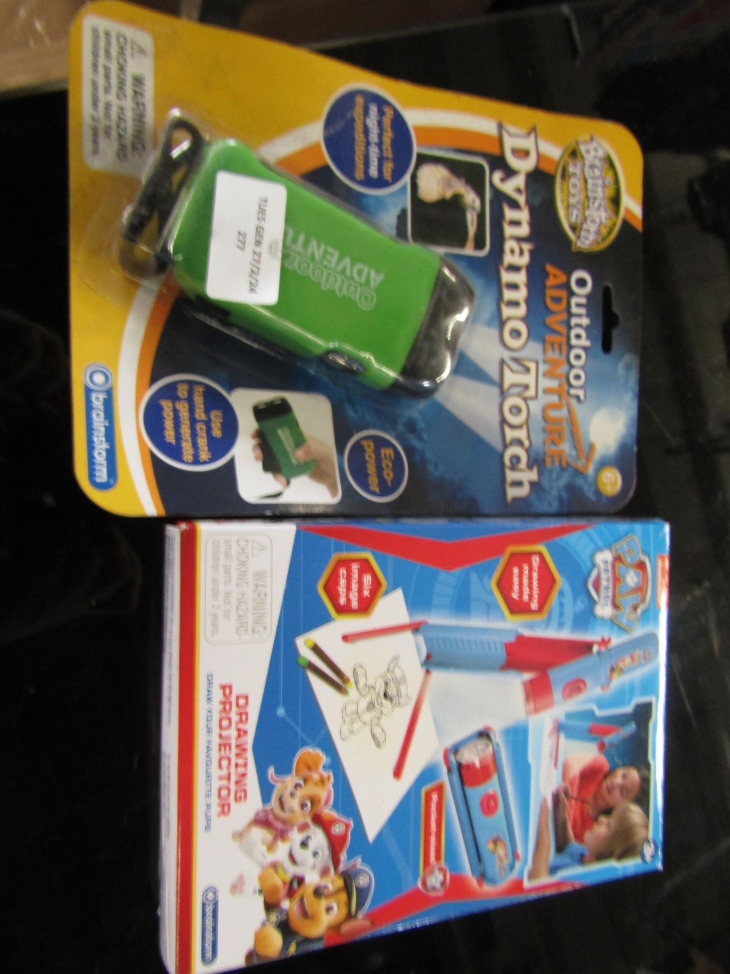 2x items being a Dynamo outdoor adventure torch and a Paw Patrol drawing projector, both unused ex