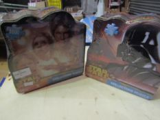 2 x Star Wars collectors puzzles. 1000 pcs in each. Product is in a sealed bag but tins are slightly