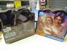 2 x Star Wars collectors puzzles. 1000 pcs in each. Product is in a sealed bag but tins are slightly