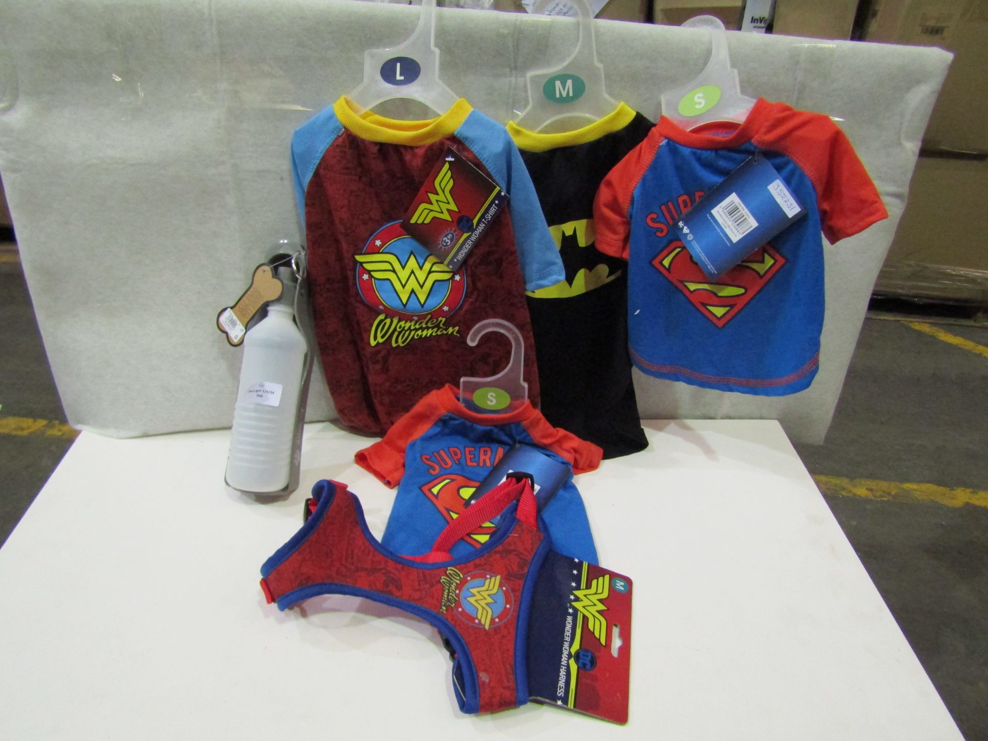 6 X Dog Items Being 1 X Foldable Water Bottle 4 X Dog T/Shirts & 1 X Wonderwoman Harness All Looks