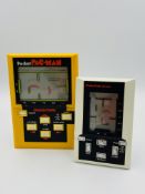 Two handheld LCD games, Grandstand Pocket Pac Man and Pac-Pac man