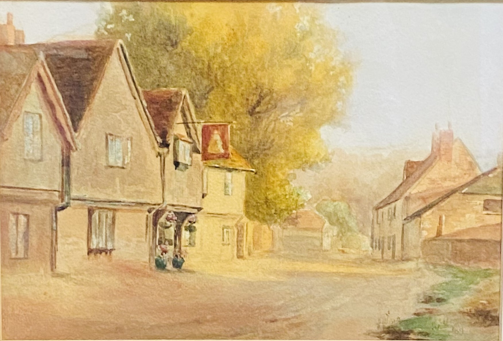 Framed and glazed watercolour of a village scene