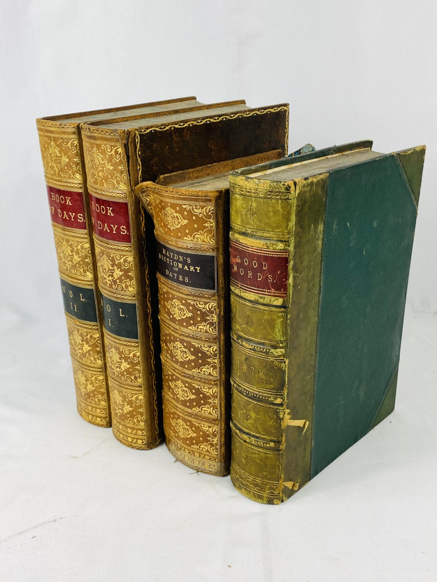 Two leather bound books together with a half bound book