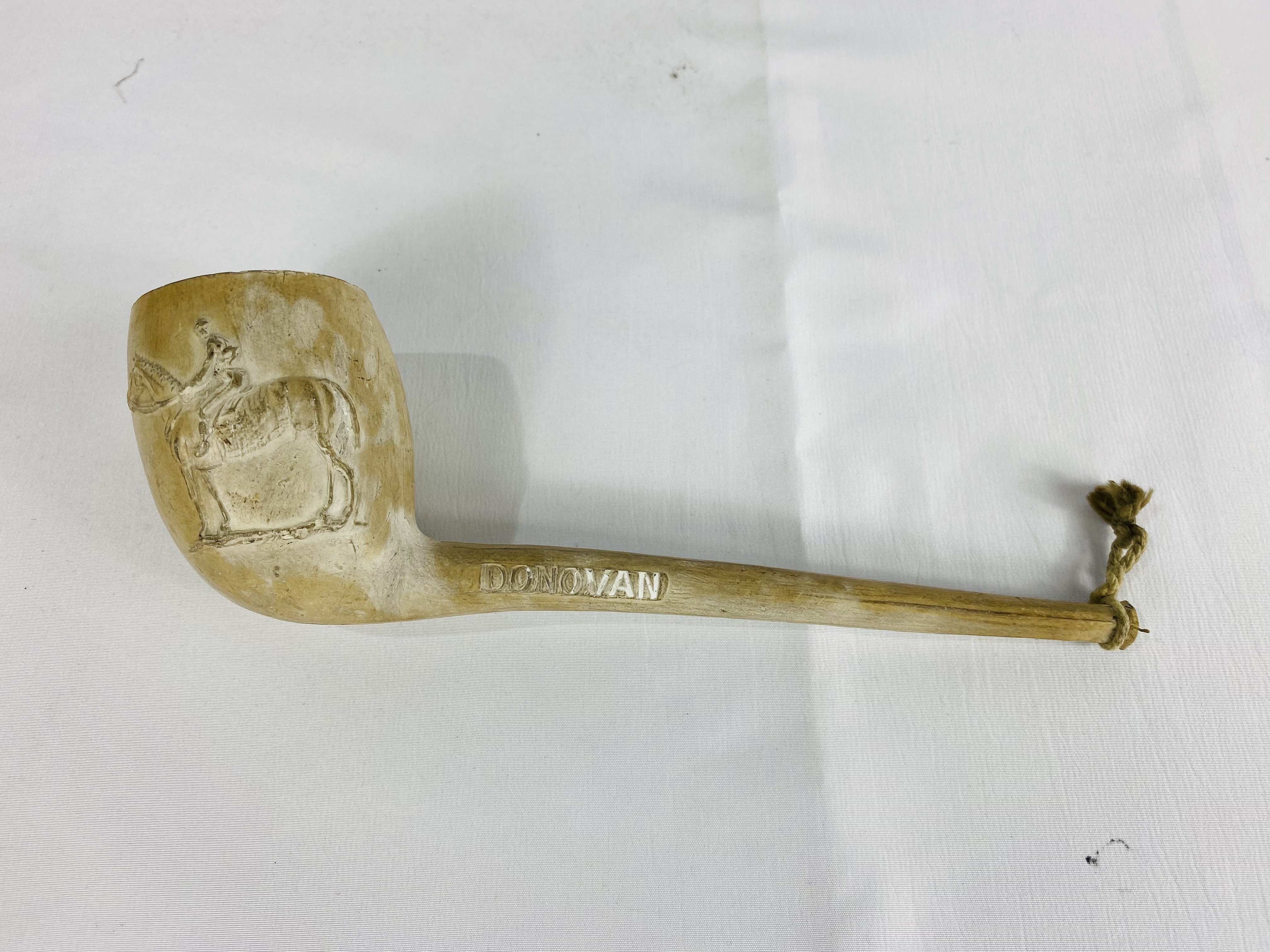 A clay pipe decorated with a jockey and racehorse, written to side Donovan and F Archer