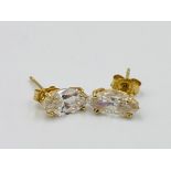 Pair of 14ct gold earrings set with a white stone