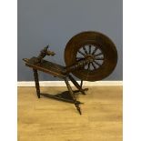 Wood spinning wheel together with a quantity of wool