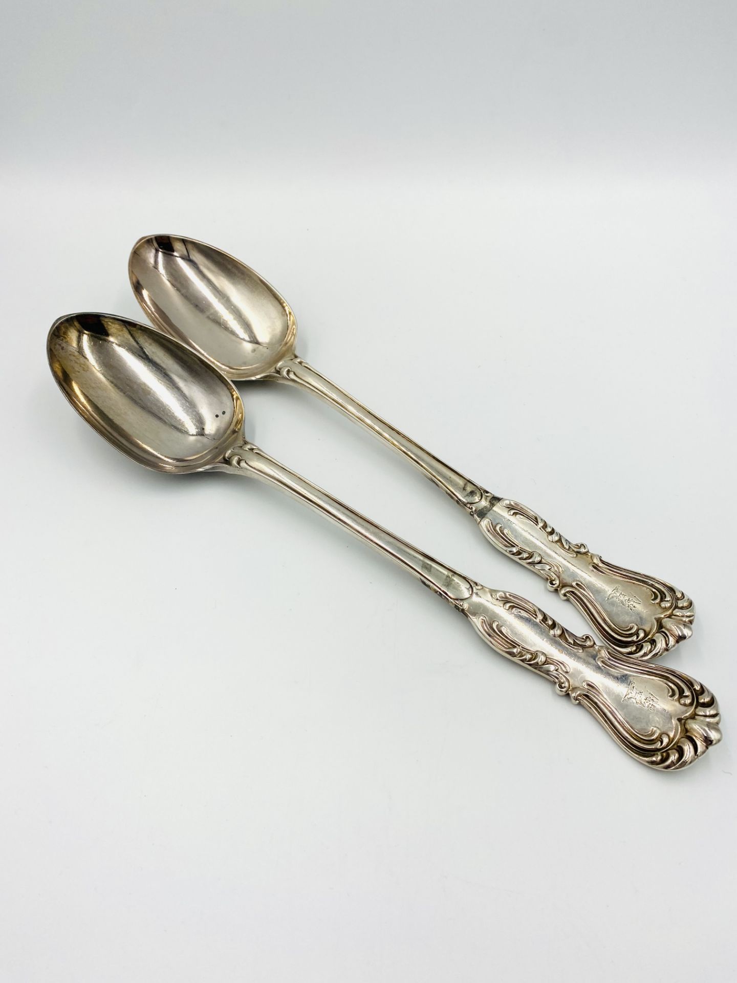 Two silver serving spoons