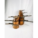 Seven Victorian tin lined copper saucepans with lids