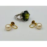 Pair of Ciro earrings together with a ring set with a tourmaline