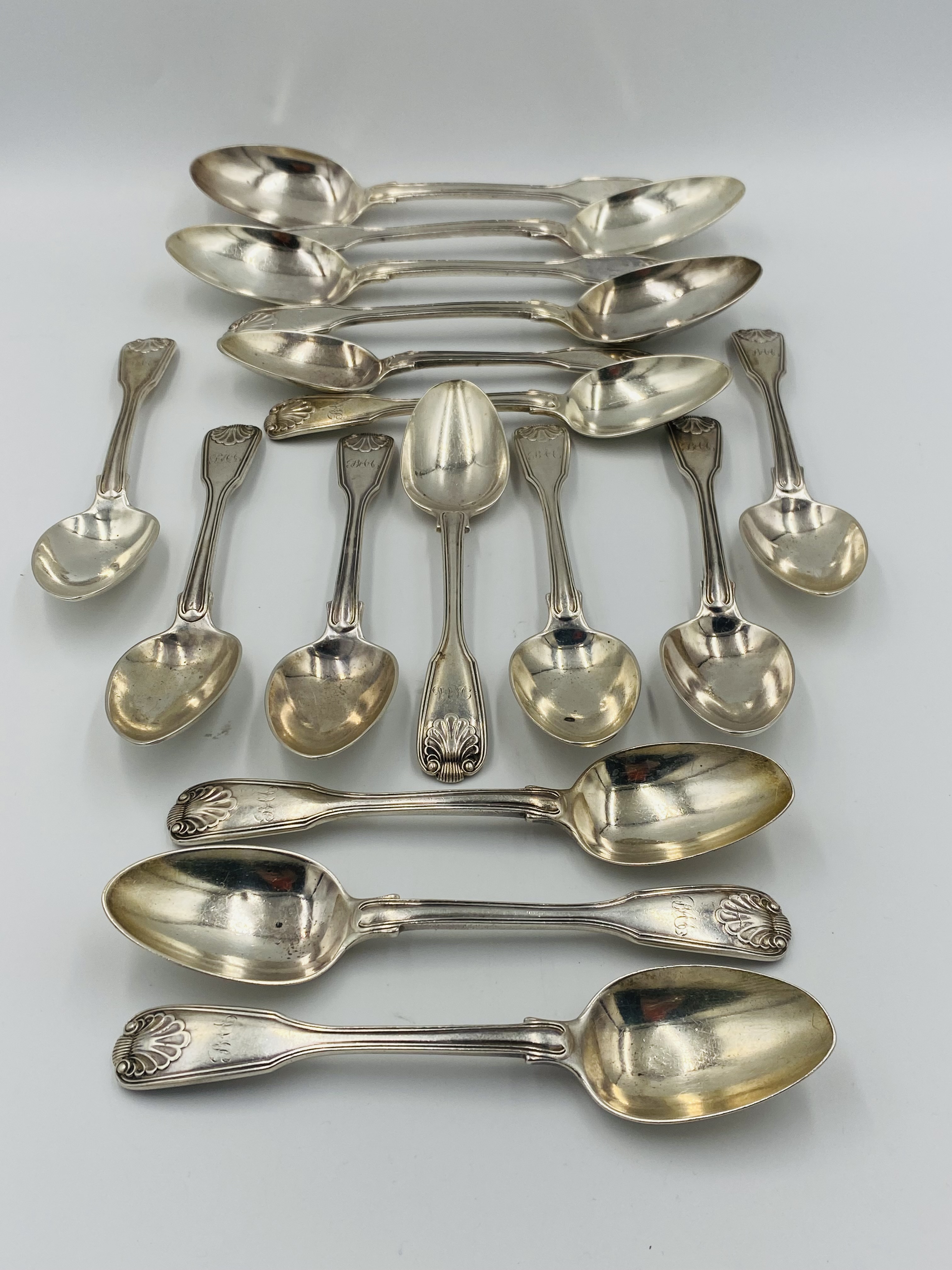 Four large and twelve smaller silver spoons