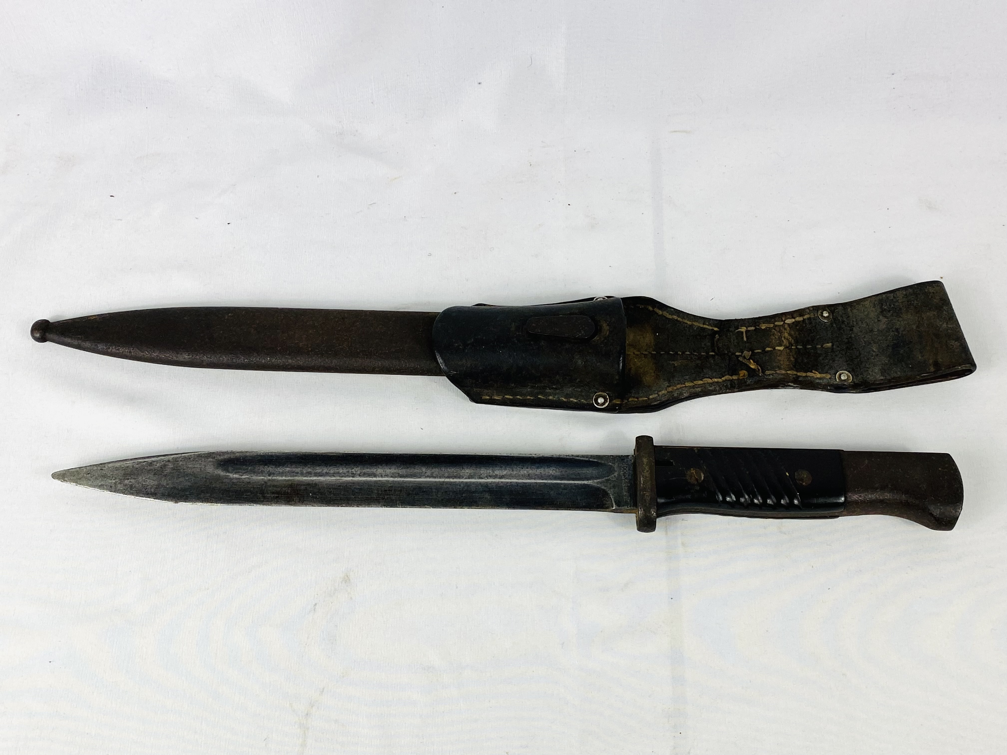 World War II bayonet written to blade Coppell G.m.b.H N20995K in leather scabbard.