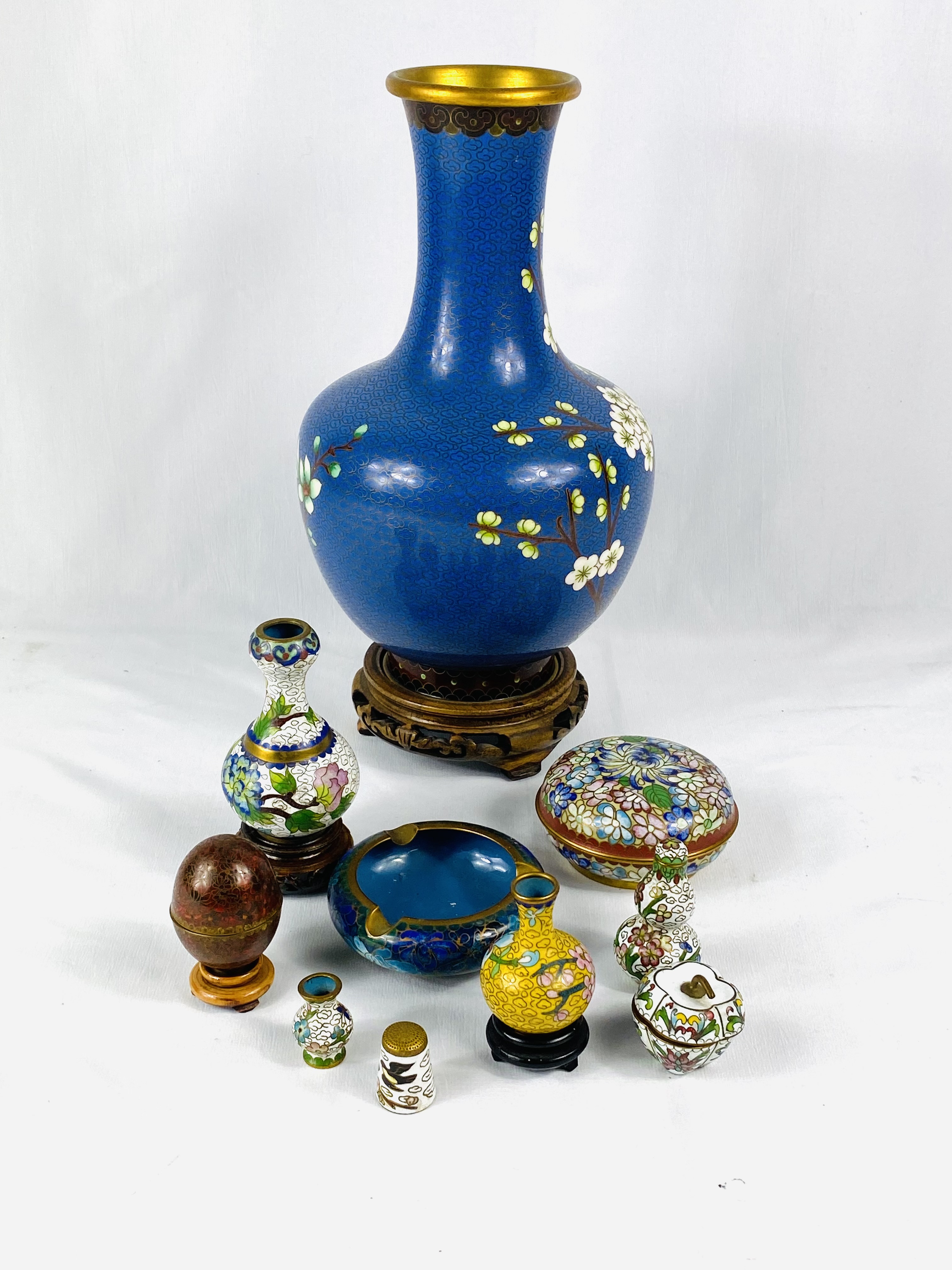 Cloisonne vase on wood base together with other items of Cloisonne.