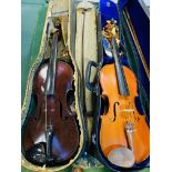 Three boxed violins with bows.