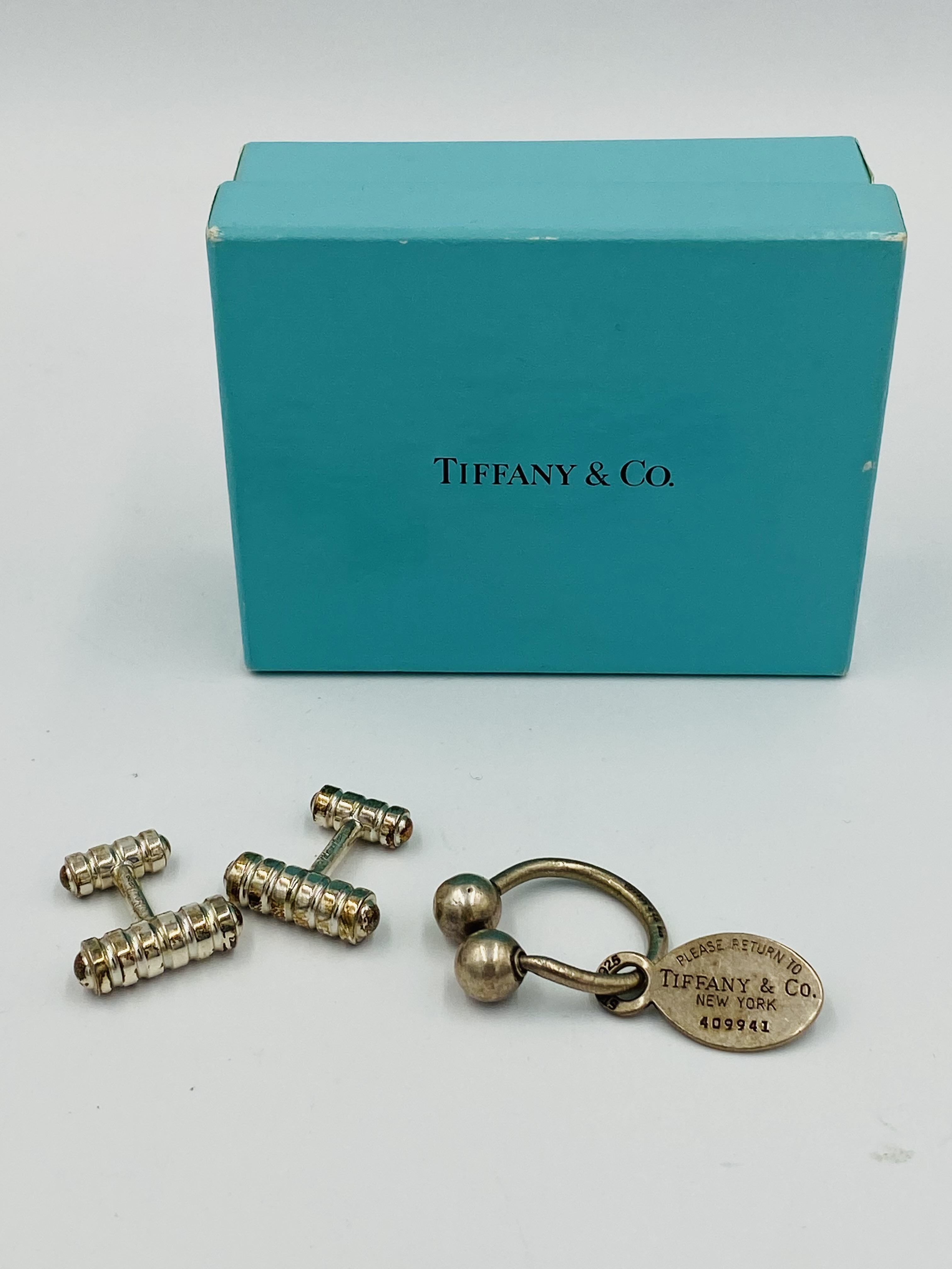 Pir of silver Tiffany cufflinks and a silver Tiffany bullring key fob.