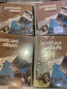 Eleven albums containing postcards.