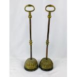 Pair of brass door stops with cast iron bases.