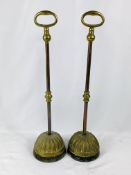 Pair of brass door stops with cast iron bases.