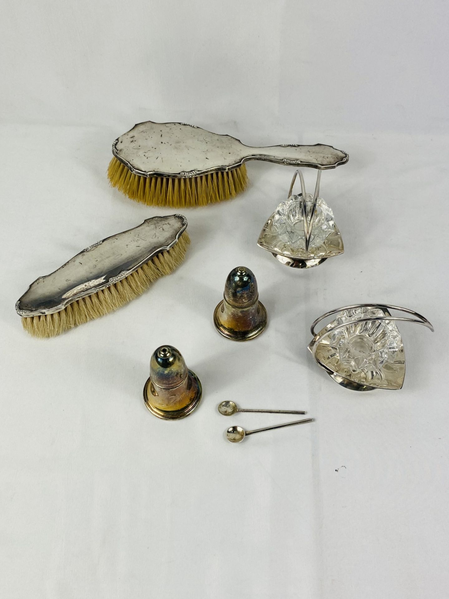 Pair of silver backed brushes; together with other items.