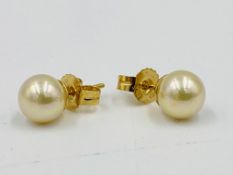 Pair of 18ct gold earrings set with a pearl