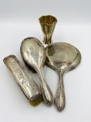 A silver dressing table set and a white metal vase