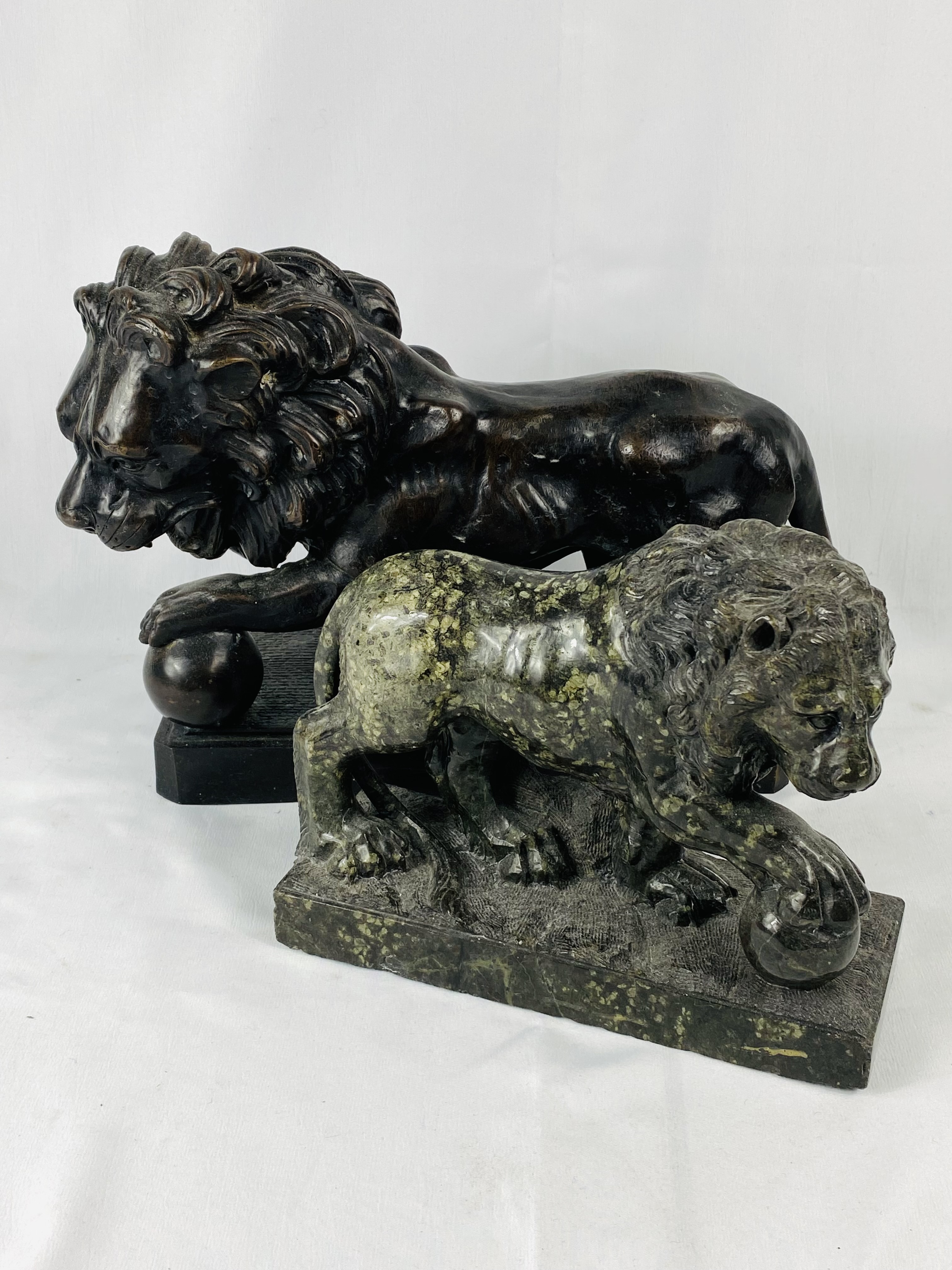 Marble lion together with a bronzed lion