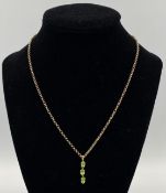 9ct gold chain with yellow metal and green stone pendant