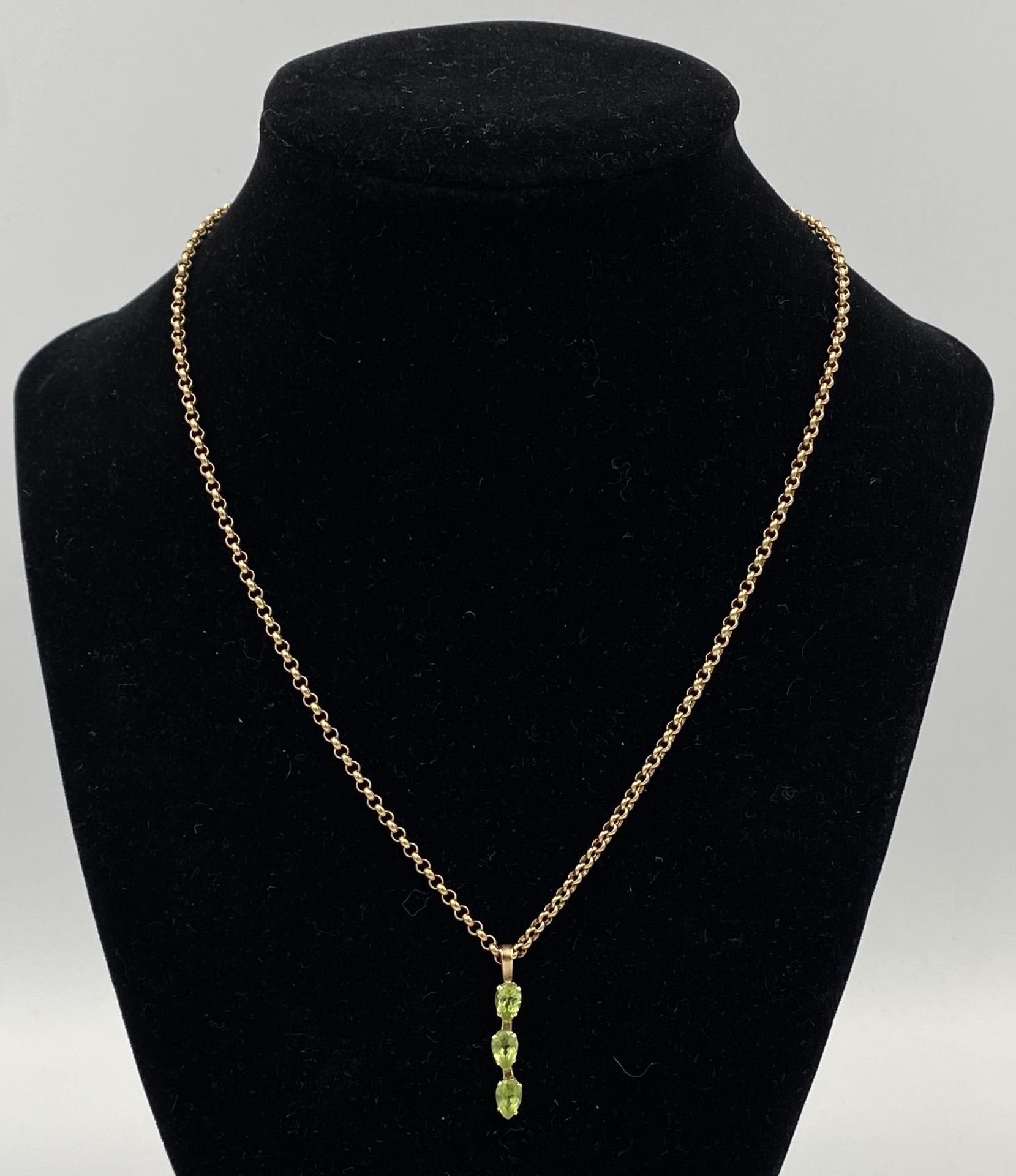 9ct gold chain with yellow metal and green stone pendant