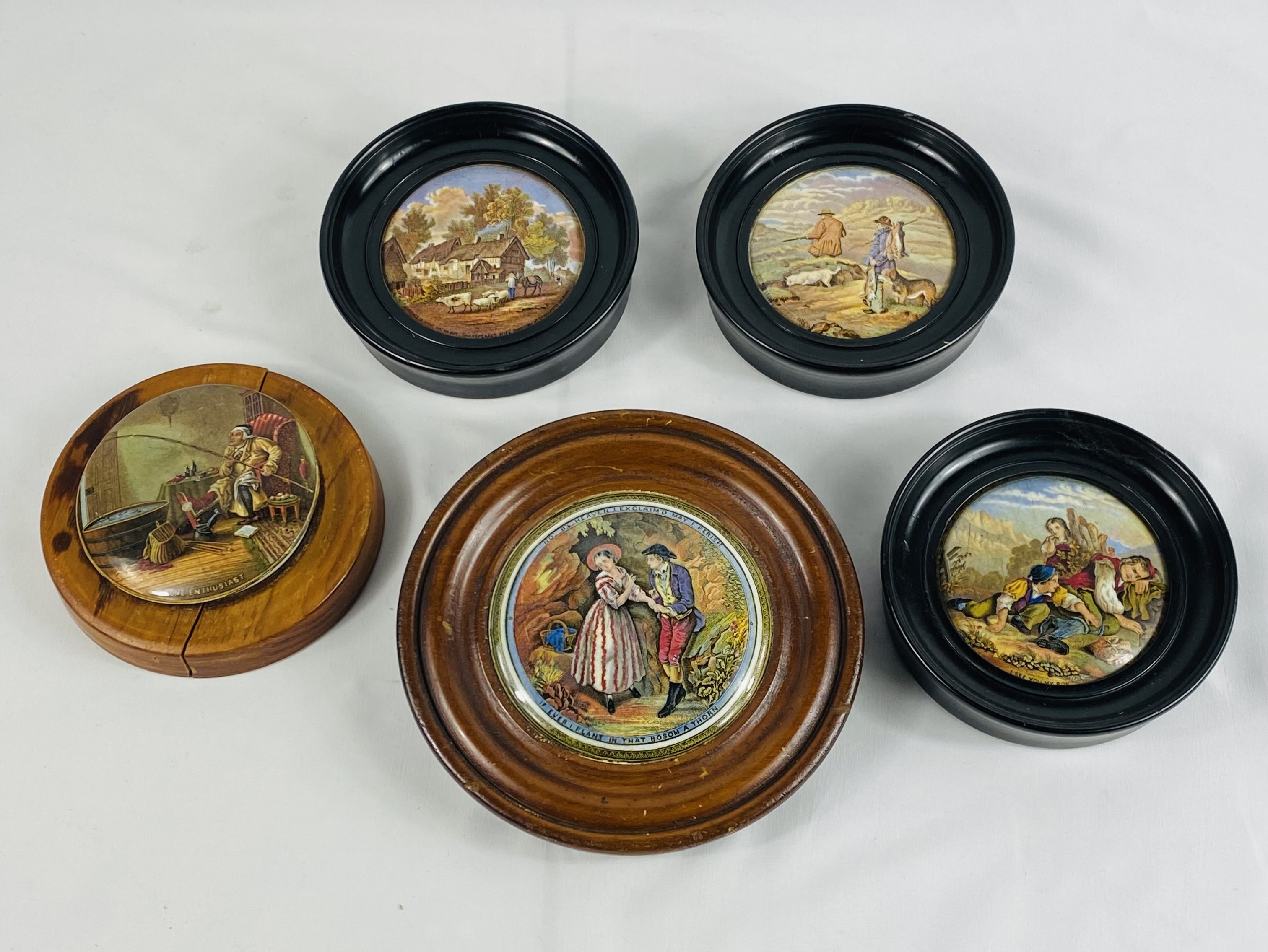 Five wood framed ceramic pot lids