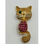14ct cat brooch set with rubies and an emerald