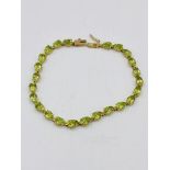 14ct gold bracelet set with green stones