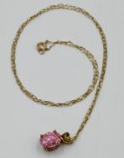 9ct gold necklace with a pink stone pendant,