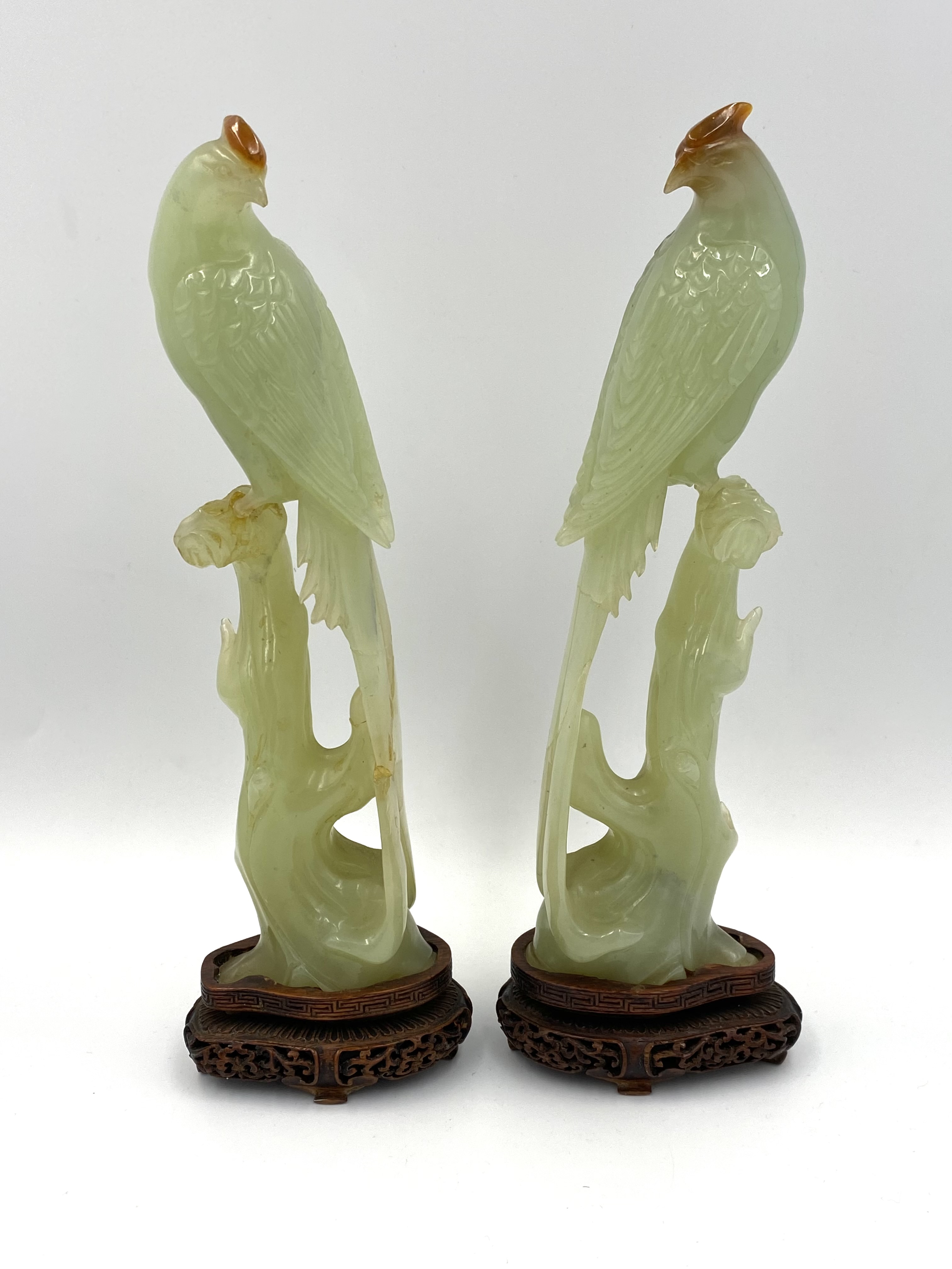 Pair of early 20th century chinese carved jade birds resting on tree stumps