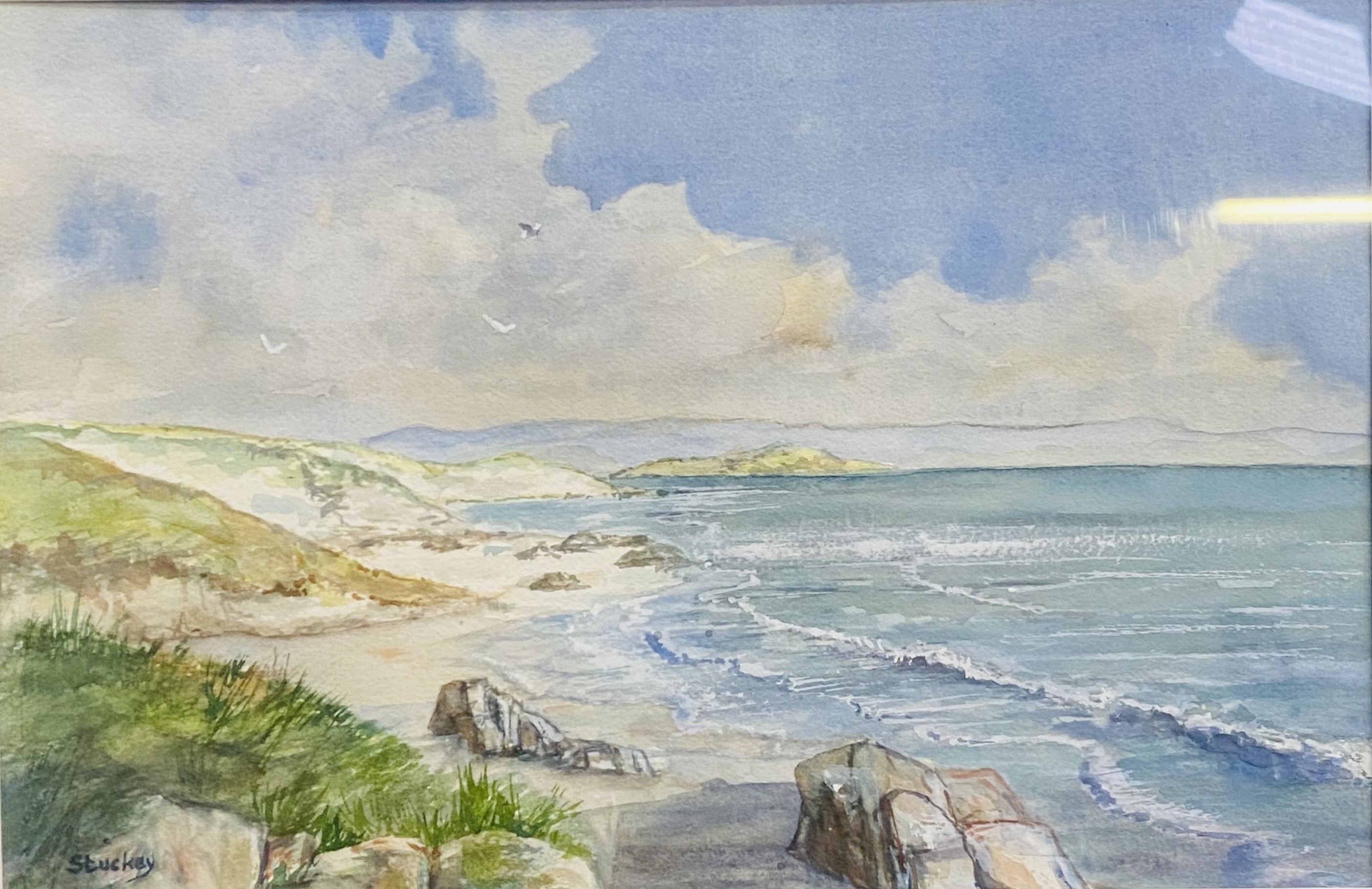 Framed and glazed watercolour of a coastal scene signed Stuckie