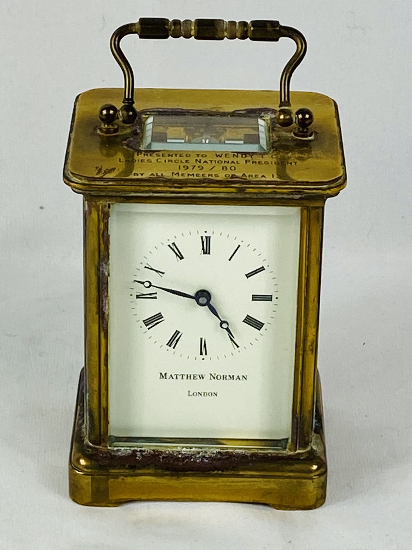 Matthew Norman brass cased carriage clock with bevel edged glass engraved to top,