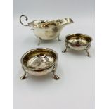 Silver sauce boat with two silver salts