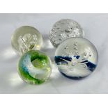 Two Selkirk glass paperweights together with two other glass paperweights