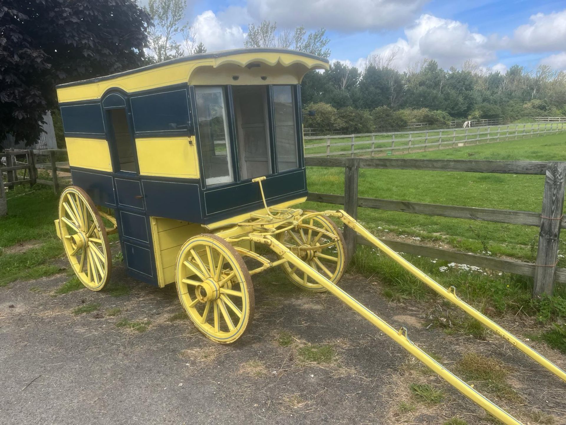 AMERICAN BUTCHER'S SHOP, a 4-wheeled enclosed van painted dark blue and yellow on iron tyres.