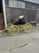 AMERICAN STUDEBAKER BUGGY featuring striking yellow wheels and undercarriage.