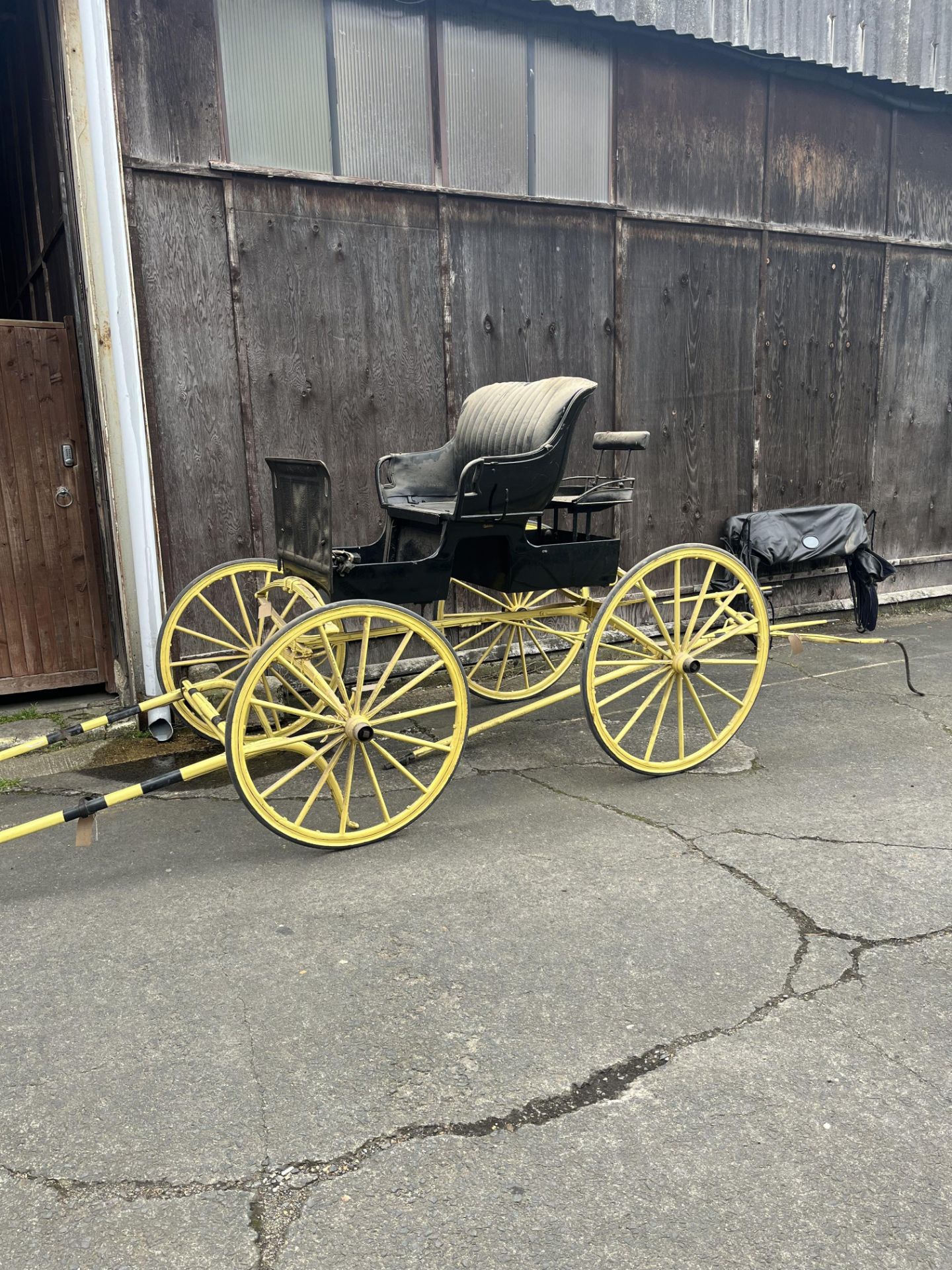 AMERICAN STUDEBAKER BUGGY featuring striking yellow wheels and undercarriage.