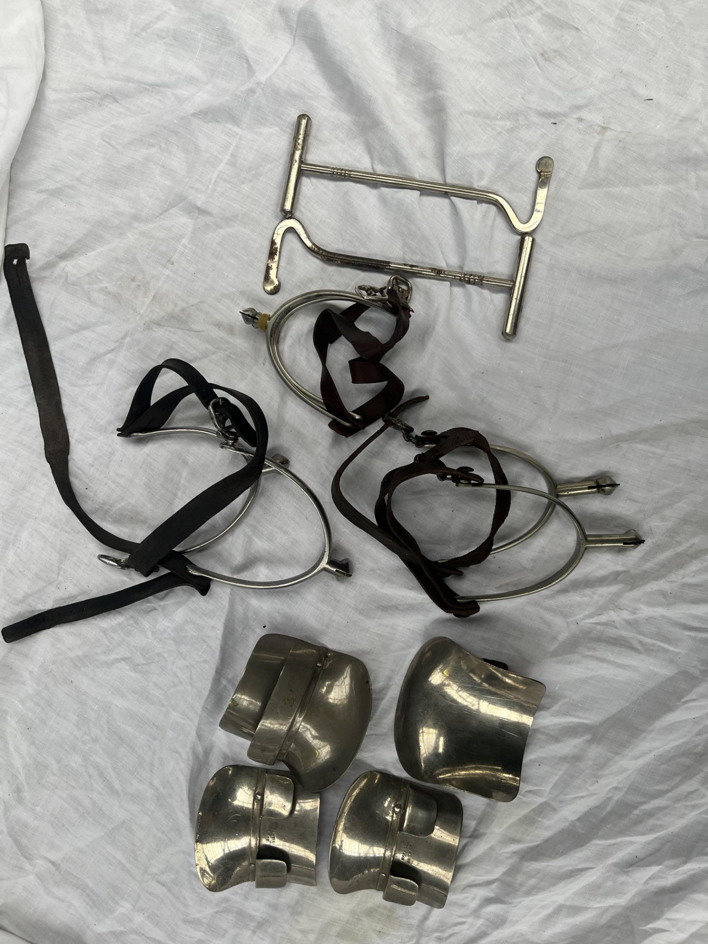 Three pairs of spurs, two sets of boot guides and a pair of boot pullers