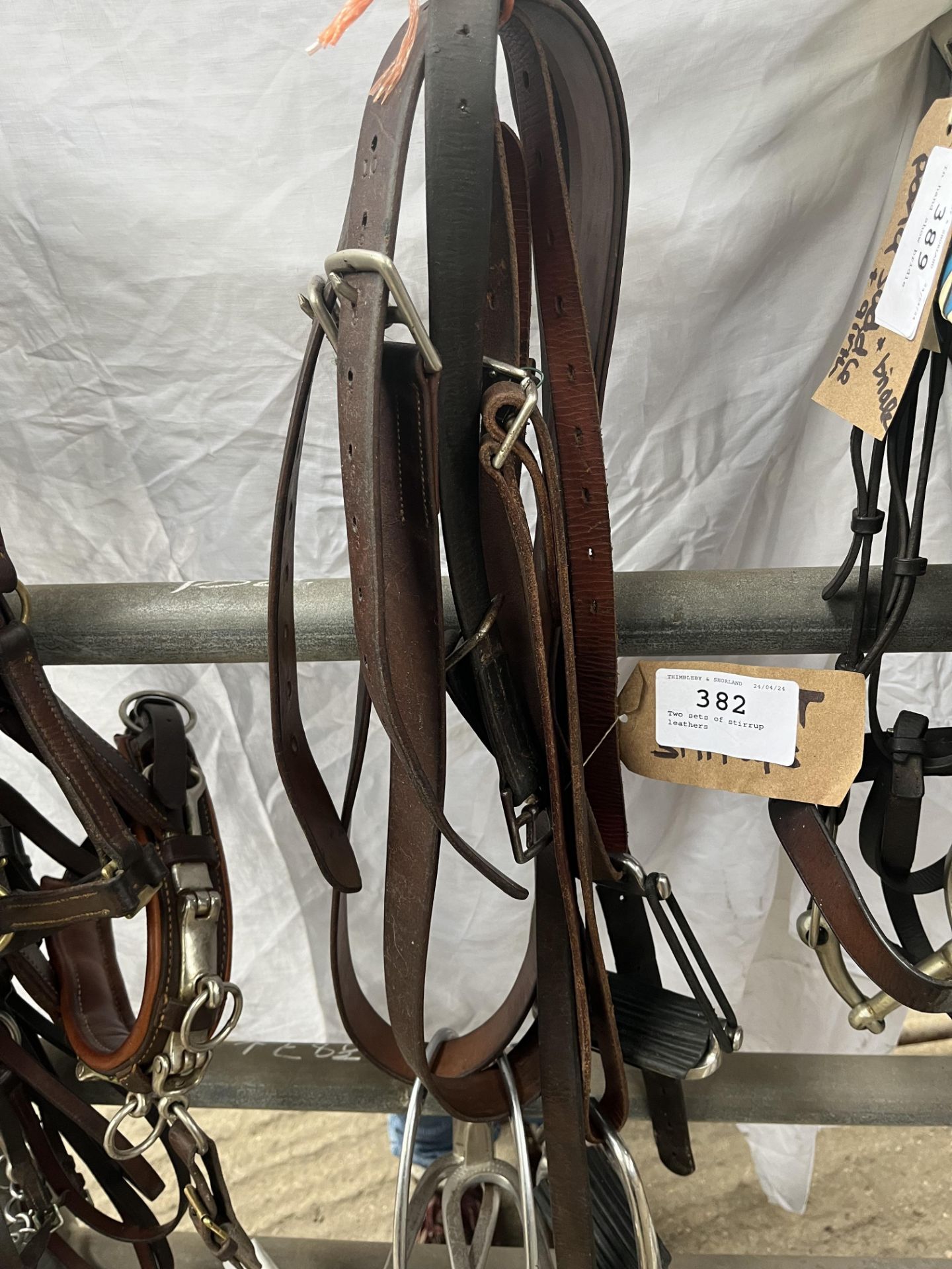 Two sets of stirrup leathers and stirrups