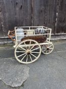 DAIRY HAND CART This charming milk float features a tricycle-style metal undercarriage.