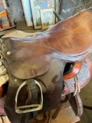 18" brown leather saddle with pair of stirrups and irons