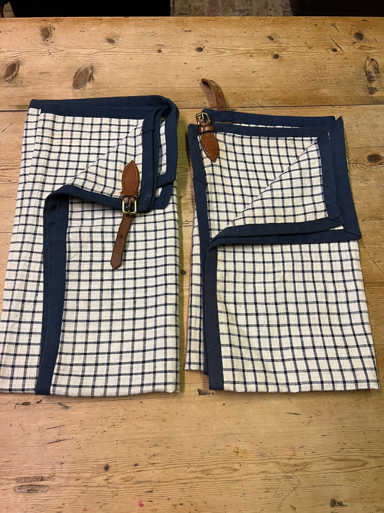 Pair of Tattersall check aprons with leather buckles