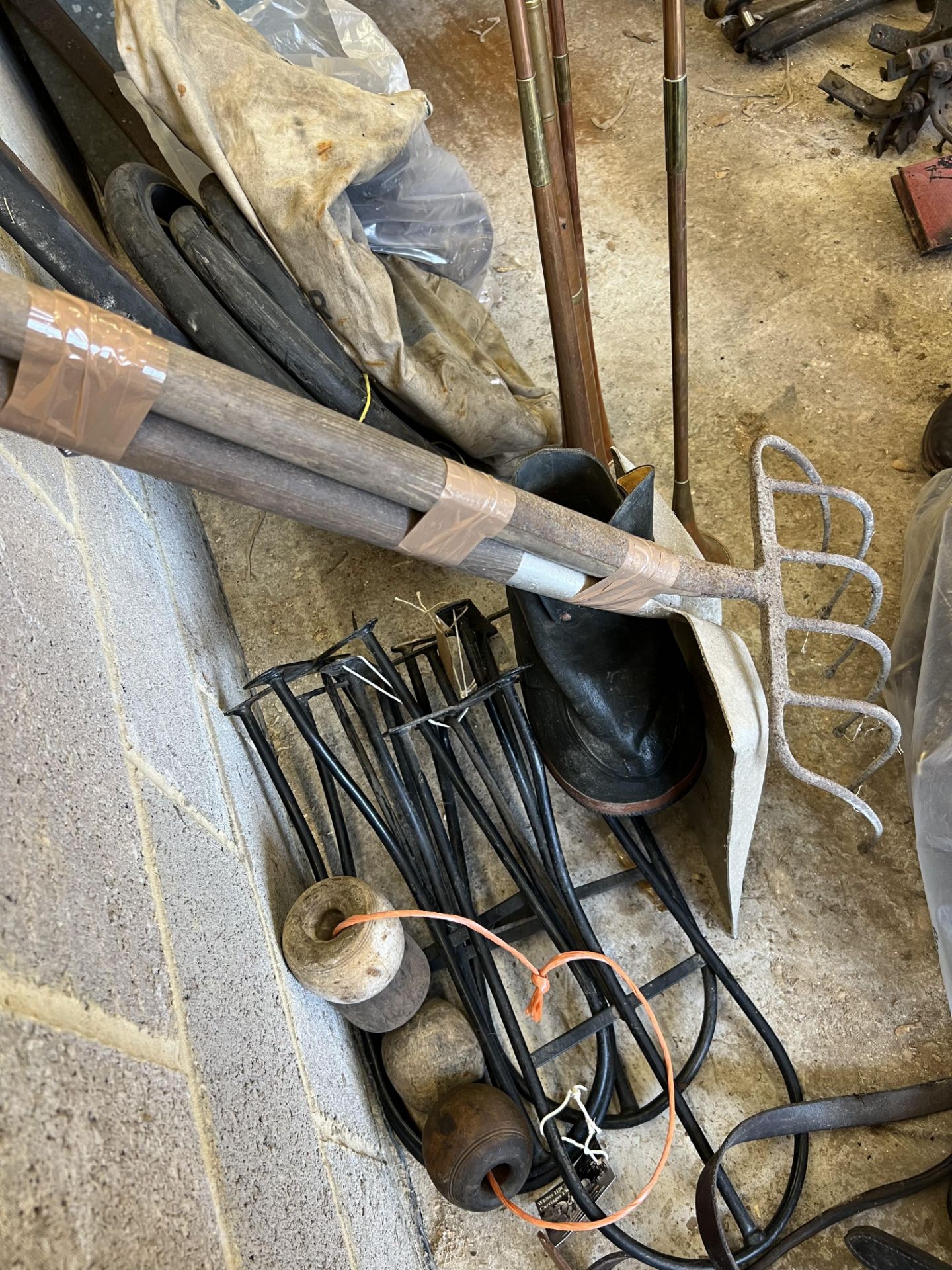 Four black saddle racks, four manger blocks, a veterinary boot and a shavings fork and shovel