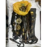 Box of heavy horse straps, some with brass, an iron yoke with chains and a shoeing tool