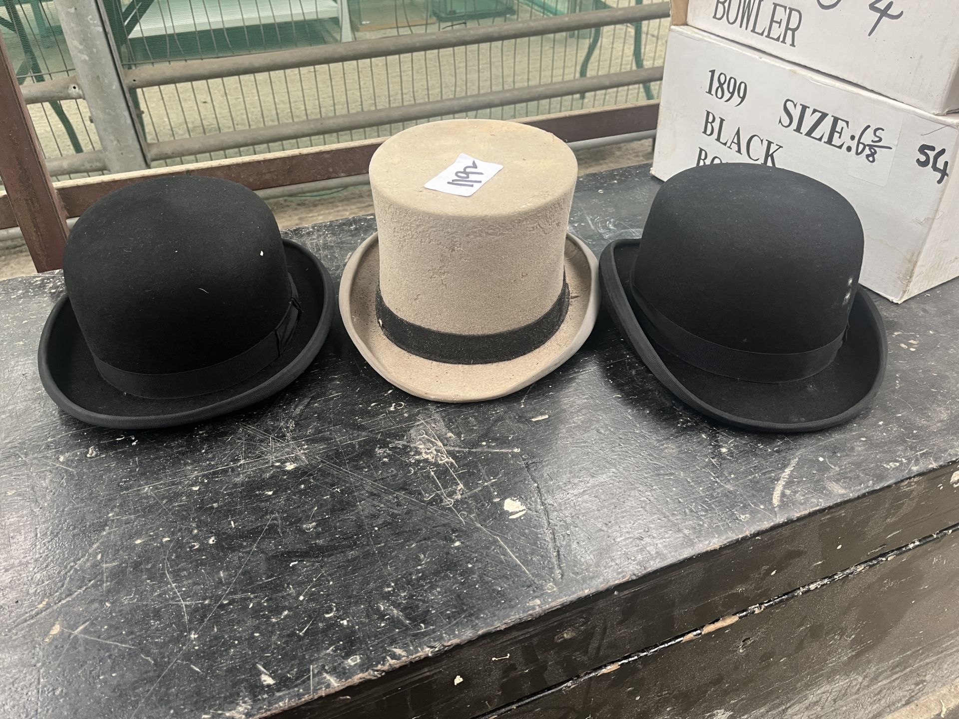 Two bowler hats and a grey top hat