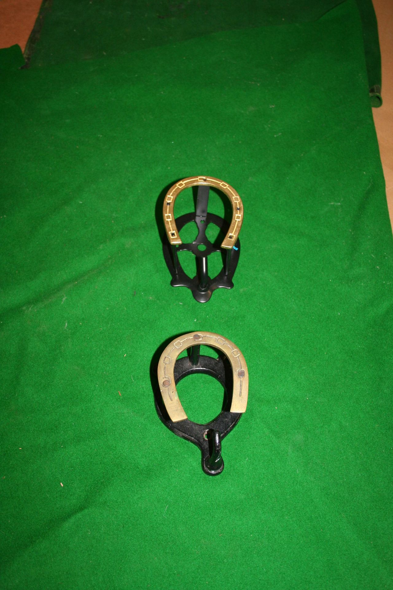 Two brass horseshoe front bridle brackets