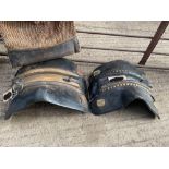 Two black leather brass mounted heavy horse saddles